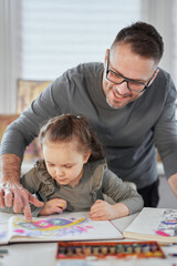 Happy art creative leisure activity. Beautiful caring art or drawing teacher in eyeglasses help to draw cute preschool girl sitting at the table, teacher enjoy helping small kid doing drawing at home