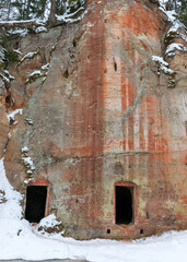 landscape with Anfabrikas rock Ligatne, artificial caves in the rock wall, all covered with snow, Ligatne, Latvia