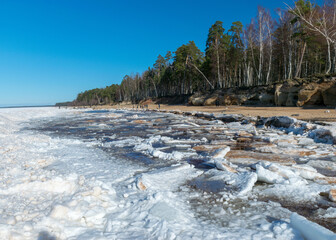 landscape with Veczemju cliffs, which are the most impressive and colorful group of sandstone cliffs on the coast of Vidzeme, ice cubes cover the dune area, Latvia