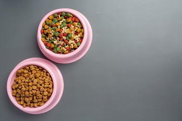 dry dog food in bowl on dark wooden backgroud