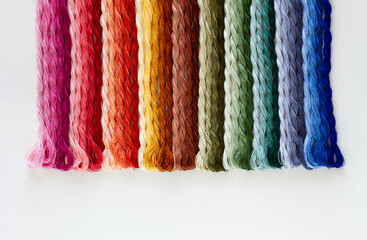 Rainbow color gradation silk embroidery thread isolated on white background. Top view.
