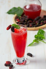 Mulberry juice on white wooden backgroud