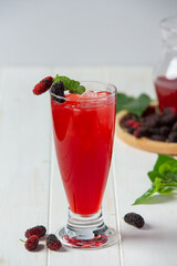 Mulberry juice on white wooden backgroud