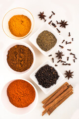 spices in ceramic bowls and white background stock photo