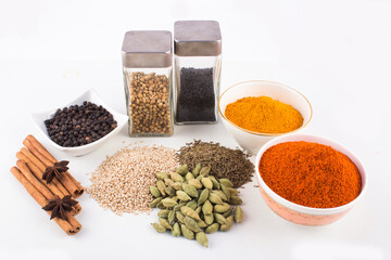 spices in ceramic bowls, glass bottles and on ground With white background stock photo