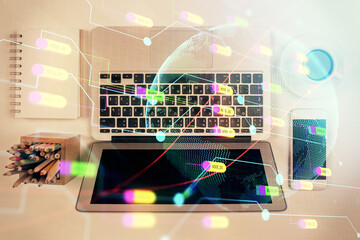 Double exposure of map hologram drawing over study table background with computer. Concept of international network. Top view.