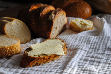 Fresh bread lies on a wooden table.