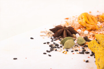 Spices: Turmeric, Chilly powder, Cardamom and cinnamon, anise stars on ground with white background stock photo