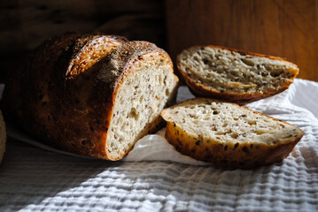 Fresh aromatic bread lies on a white napkin.