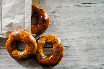 Bagels on a wooden table. Baking with poppy seeds.