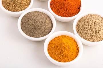 Various spices in ceramic bowls isolated on white background. stock photo
