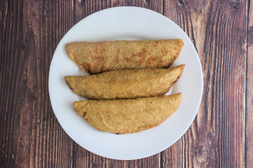 Plate with three quesadillas and jalapeño peppers, typical mexican food