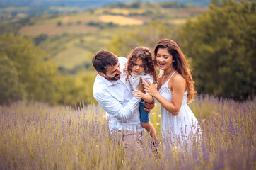 Naklejka na ściany i meble Happy family in lavender field.
