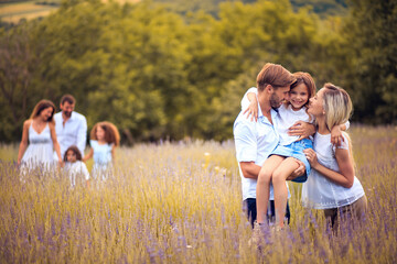 Naklejka na ściany i meble Large group of people in lavender field. Focus is on foreground.