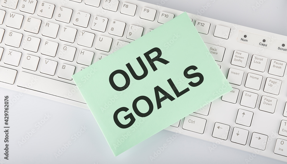 Poster text our goals on envelope on keyboard on the white background