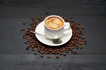 Cup of espresso coffee on dark wooden background