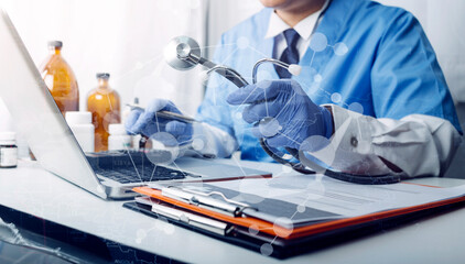 Medical technology concept The doctor works with mobile phones, headphones and tablets. Digital laptop Pressing the calculator in the modern office at the hospital in the morning