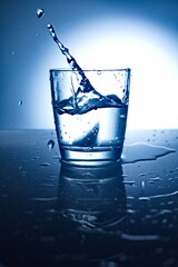 Ice Cubes Splashing Into Glass Of Water.