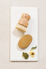 Eco friendly cleaning tools and products. Herbal natural soap and kitchen brush on white natural background.