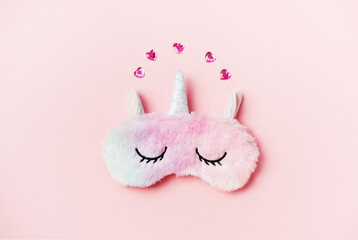 Pink sleeping eye mask on a pink background.Top view, flat lay. Concept relaxation and sweet dreams