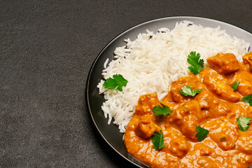Plate of Traditional Chicken Curry and rice on dark concrete background