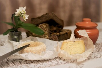 A homemade cheese, bread and an orchid