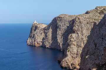 Fototapeta na wymiar Lighthouse on Cap Formentor Cliffs leading towards the ocean, Mallorca, Spain