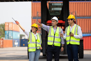 factory workers or engineers pointing something in containers warehouse storage