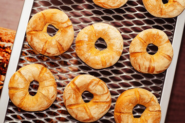 Sweet buns on a baking sheet. Preparing dough food in a small bakery. Close-up