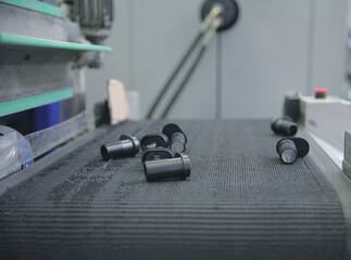 Selective focus shot of black bolts on the production l