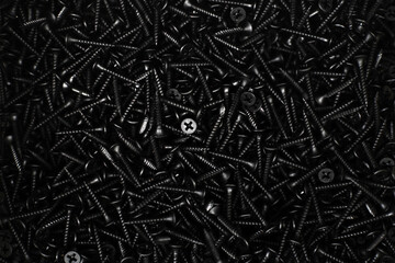 Many black metal screws. Flat lay frame - obrazy, fototapety, plakaty