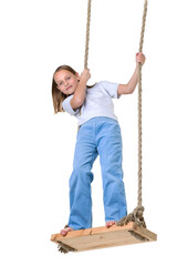 Preteen girl having fun on rope swing