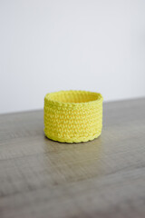 knitted round basket on table and white background