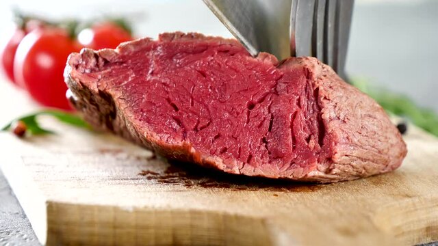 cutting grilled beef fillet