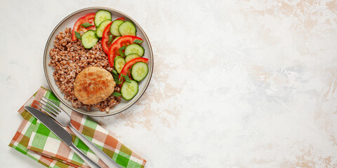 Delicious home lunch - buckwheat with chicken cutlets and vegetables. Top View