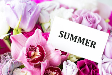 Summer text on the card against the background of flowers