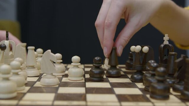 Two players make their moves in chess game close-up. colleagues playing chess to development analysis new strategy plan, leader and teamwork concept for success. Relationship of man and woman
