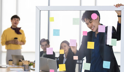 A cheerful and joyful transgender tomboy businessman standing and explaining the idea and work...