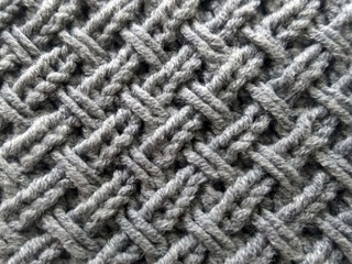 Handmade knitted fabric in gray with a diagonal pattern