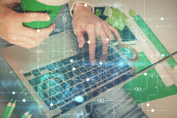 Double exposure of woman hands working on computer and data theme hologram drawing. Tech concept.