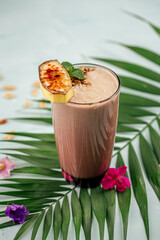 Glass of chocolate smoothie cocktail on the blue background