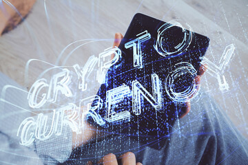 Double exposure of man's hands holding and using a phone and crypto currency blockchain theme drawing.