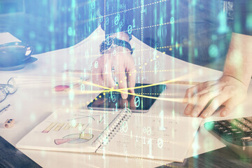Double exposure of man's hand holding and using a digital device and data theme drawing. Technology concept.