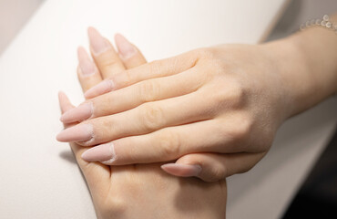 elegant female hands before procedure manicure in a beauty salon