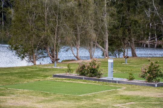 Empty Powered Camping Site For Caravans. Camper Trailers And Motorhomes At The Caravan Holiday Park On The Lake