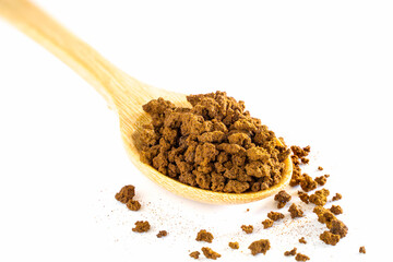 Instant coffee powder in a wooden spoon