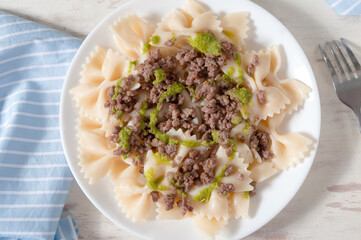 Delicious farfalle with freshly made pesto and minced meat.