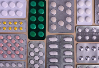 Tablets of different colors and sizes. Background of tablets. Numerous medications.