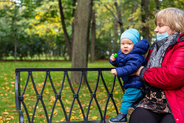 Fototapeta na wymiar grandmother and grandson in an autumn park
