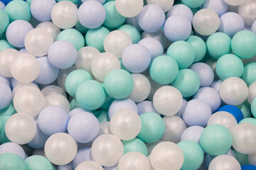 Abstract background from plastic balls of white, blue and green colors